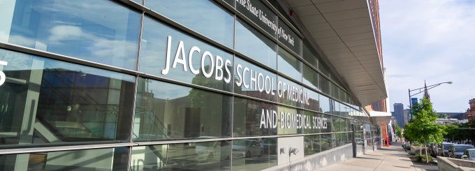 Jacobs School exterior with lettering that reads: University at Buffalo the State University of New York Jacobs School of Medicine and Biomedical Sciences. 