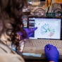 Scientist pointing at computer screen. 