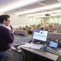 Presenter in front of a lecture hall. 