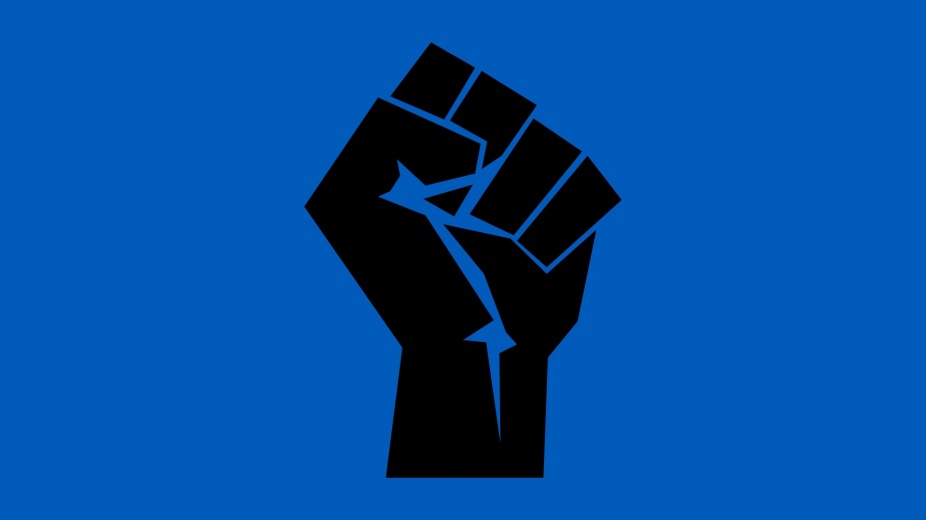 black fist over blue background. 