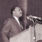Martin Luther King Speaking on a podium. 