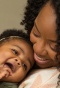 Black family smiling: father baby and mother. 