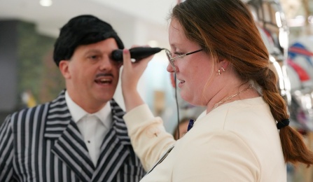 Medical student holding an occular ultrasound scan against Dan Mirch's eye. 
