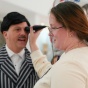 Medical student holding an occular ultrasound scan against Dan Mirch's eye. 