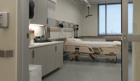 A view of the simulation room with an empty hospital bed. 