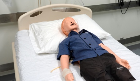Laerdal's SimJunior in a hospital bed.