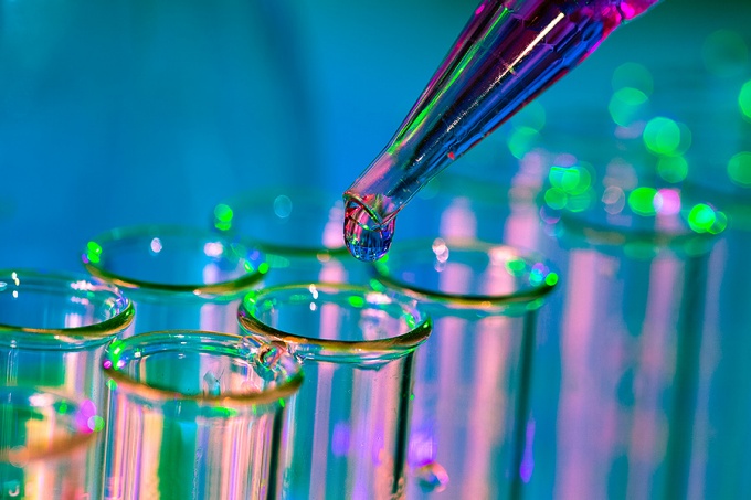 Pipette adding fluid to one of several test tubes. 