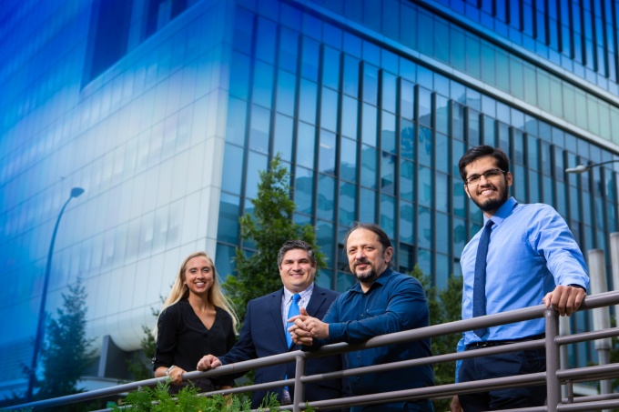 Zoom image: Members of the QAS.AI team. Left to right: Kelsey Sommer, chief operating officer; Vincent Tutino, chief financial officer; Ciprian Ionita, CEO; and Mohammad Mahdi Shiraz Bhurwani, the company&rsquo;s lead AI scientist over summer 2021. Sommer and Bhurwani are UB PhD students. Tutino and Ionita are UB faculty members. Credit: Douglas Levere / University at Buffalo 